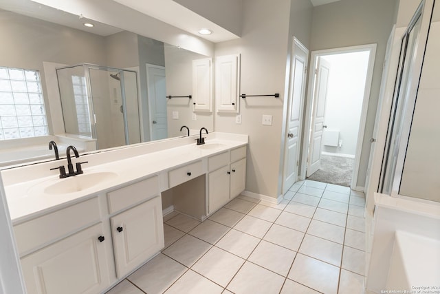 bathroom featuring vanity, shower with separate bathtub, and tile patterned flooring