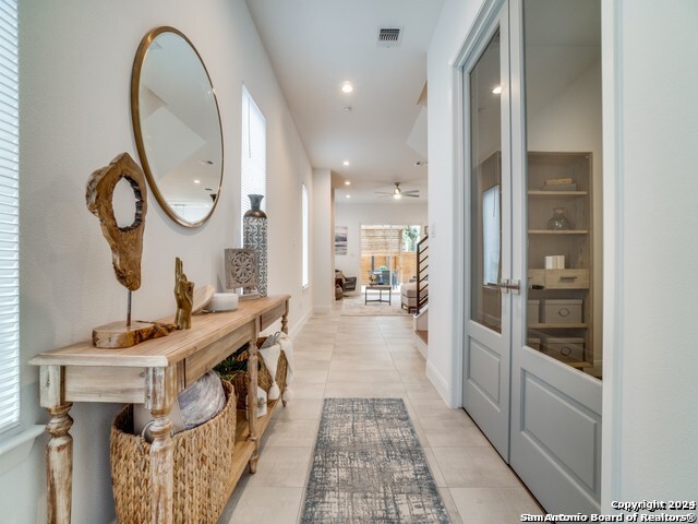 hall featuring light tile patterned floors