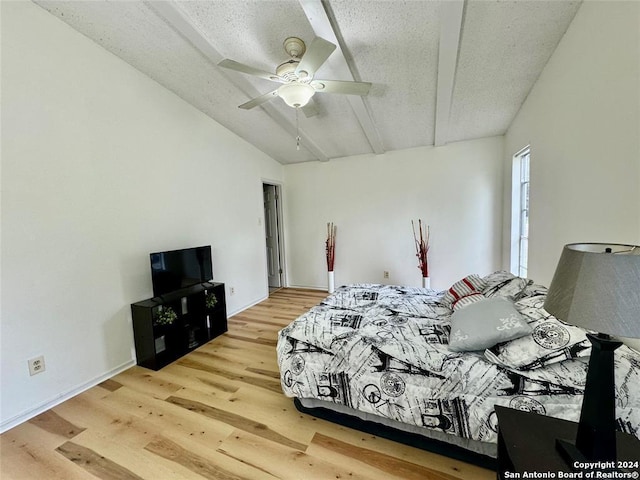 bedroom with ceiling fan, wood-type flooring, and a textured ceiling