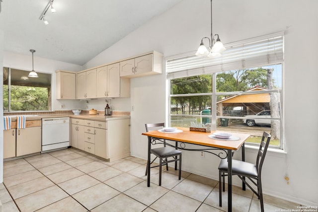 kitchen featuring pendant lighting, an inviting chandelier, white dishwasher, vaulted ceiling, and light tile patterned floors