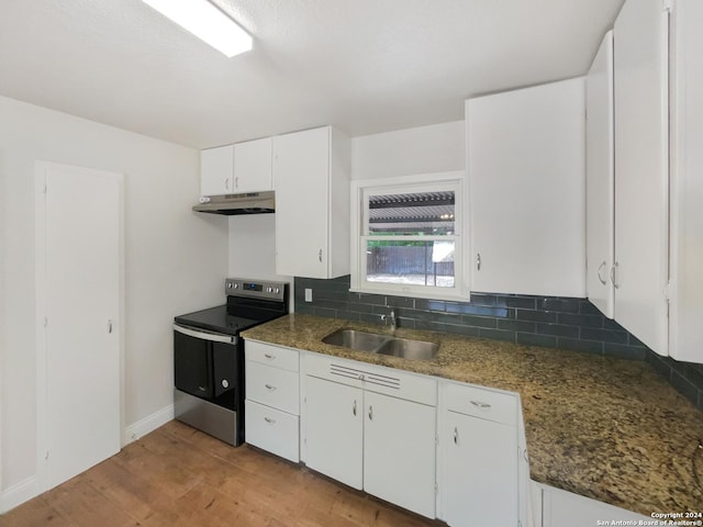 kitchen featuring sink, white cabinets, stainless steel range with electric cooktop, backsplash, and light hardwood / wood-style floors