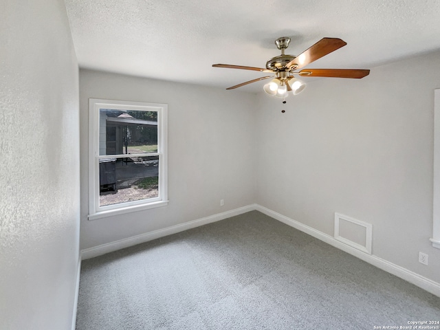 spare room with a textured ceiling, ceiling fan, and carpet flooring