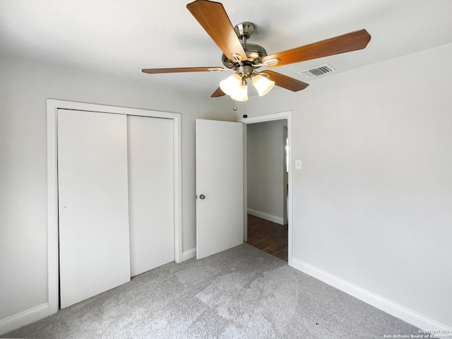 unfurnished bedroom featuring a closet, carpet floors, and ceiling fan