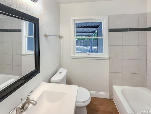 full bathroom with tiled shower / bath combo, toilet, tile patterned floors, and sink