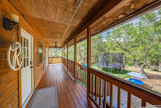 deck featuring a porch and a trampoline