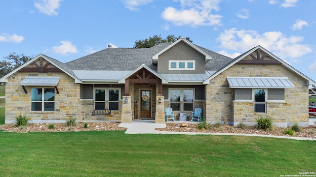 craftsman house with a front yard and covered porch