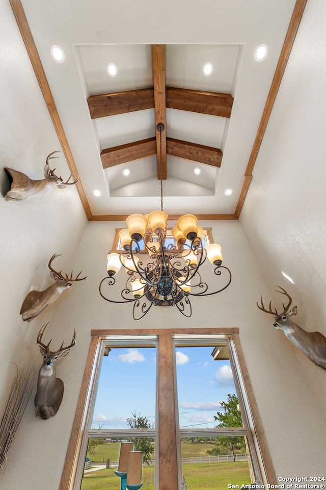 room details with beam ceiling, coffered ceiling, and an inviting chandelier