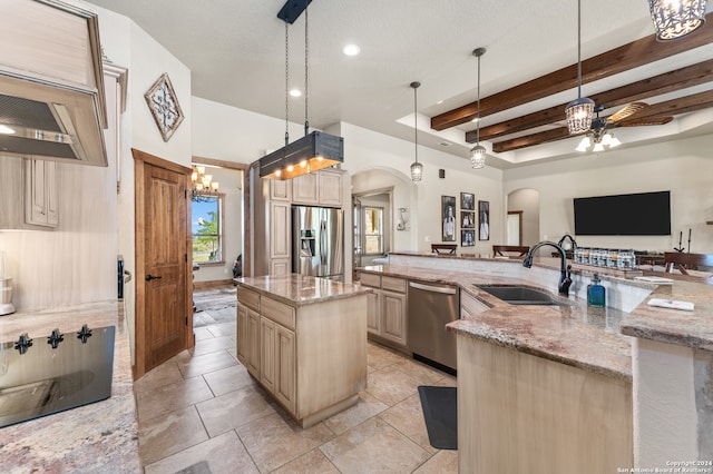 kitchen with beamed ceiling, stainless steel appliances, a center island with sink, hanging light fixtures, and light stone countertops