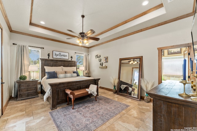 bedroom with multiple windows, a tray ceiling, and light tile patterned floors