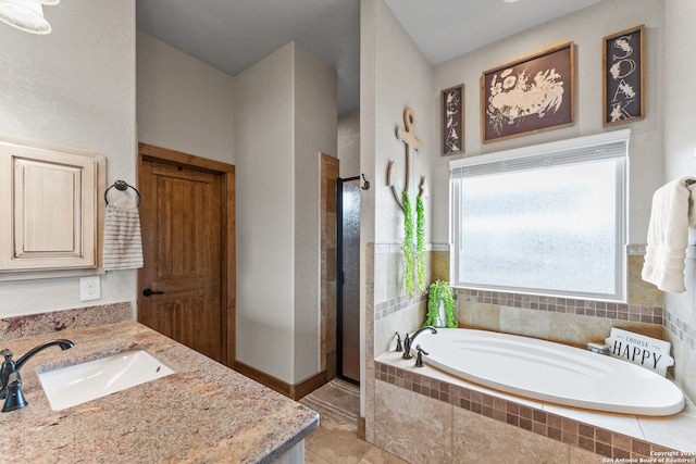 bathroom with vanity, tile patterned floors, and separate shower and tub