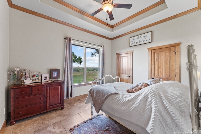 tiled bedroom with a tray ceiling, crown molding, and ceiling fan