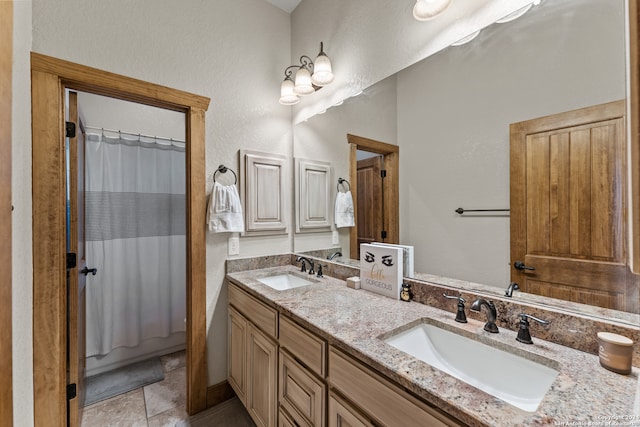 bathroom with dual vanity and tile patterned flooring