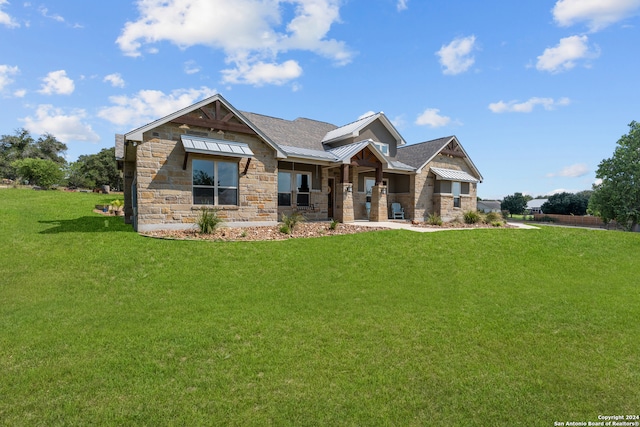 craftsman-style home featuring a front lawn