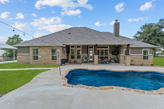 view of swimming pool featuring a patio area and a yard