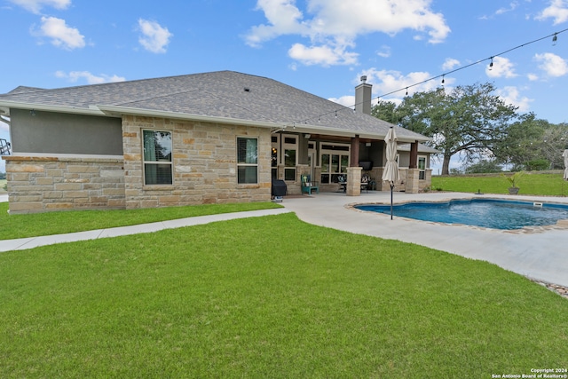 rear view of property featuring a patio and a lawn