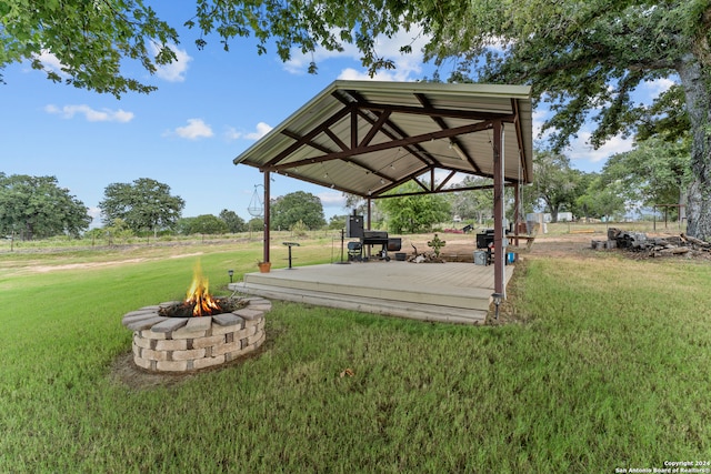 view of yard with a deck, a gazebo, and an outdoor fire pit