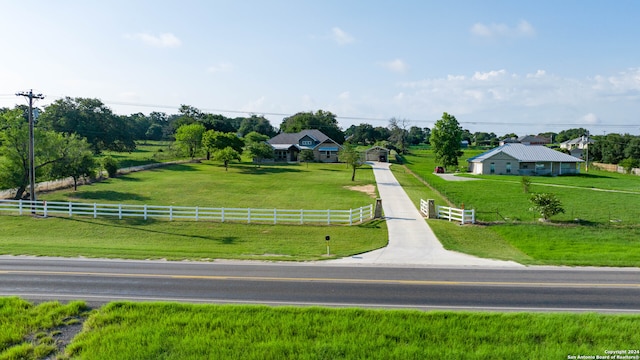 view of community with a lawn and a rural view