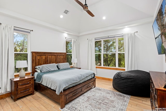 bedroom featuring multiple windows, light hardwood / wood-style flooring, and ceiling fan