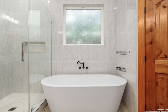 bathroom with plus walk in shower and tile walls