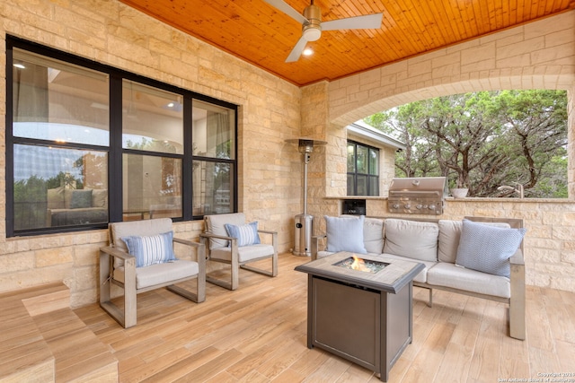 view of patio / terrace featuring a fire pit, ceiling fan, and area for grilling