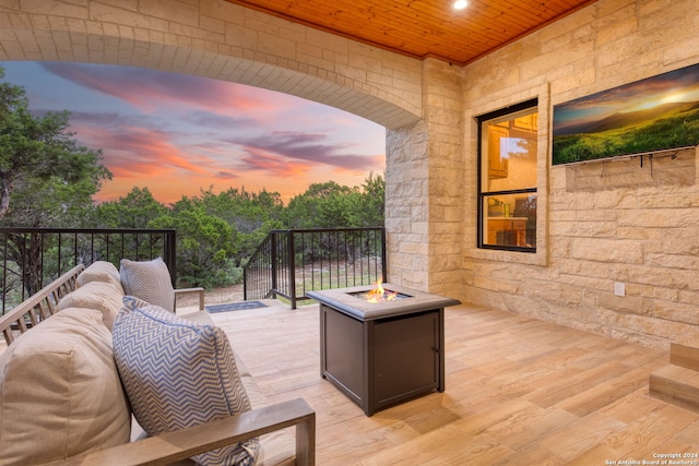 view of patio with a deck and a fire pit