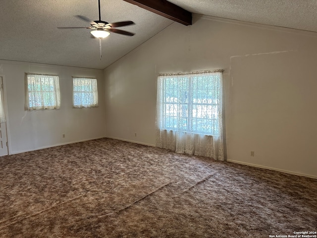 spare room featuring carpet, a healthy amount of sunlight, lofted ceiling with beams, and ceiling fan