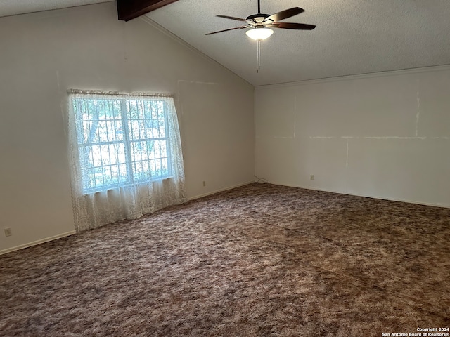 carpeted empty room with a textured ceiling, ceiling fan, and vaulted ceiling with beams