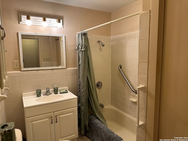 bathroom with decorative backsplash, tile walls, shower / bath combo with shower curtain, and vanity