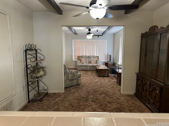 hall with dark colored carpet and a textured ceiling