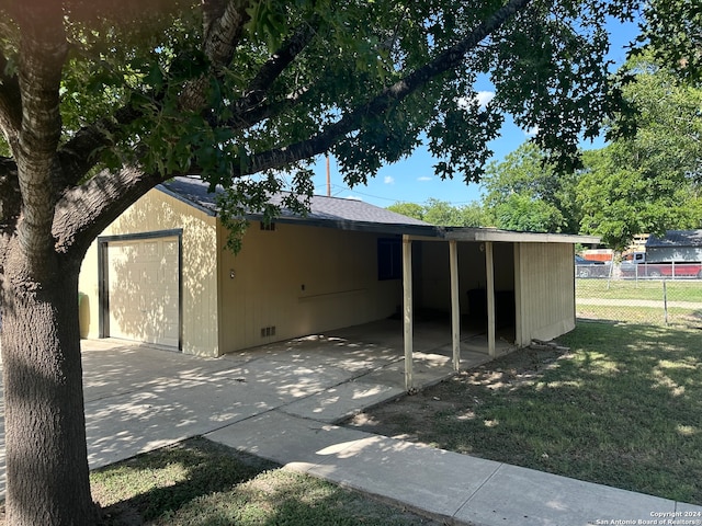 exterior space featuring a carport and a yard