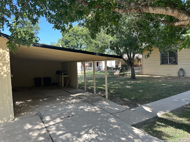 exterior space featuring a carport and a yard