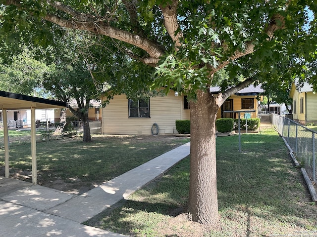 obstructed view of property with a front lawn