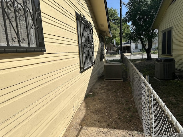 view of side of property featuring central AC