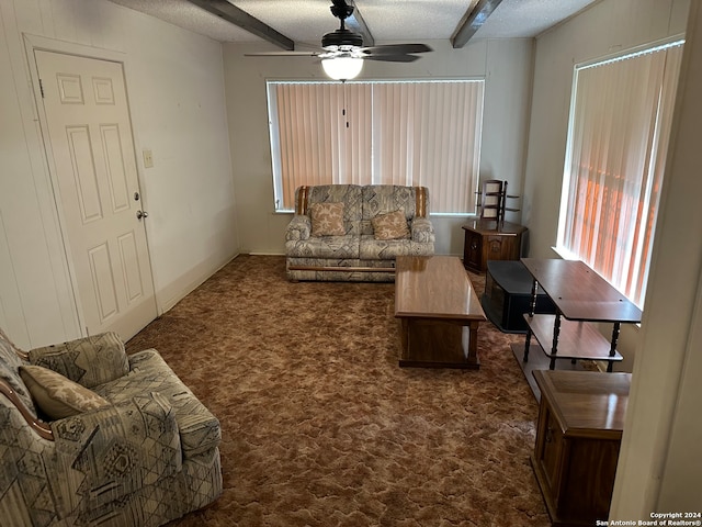 carpeted living room with a textured ceiling and ceiling fan