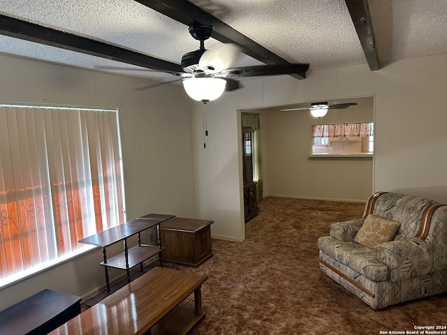 carpeted living room featuring beam ceiling, a textured ceiling, and ceiling fan