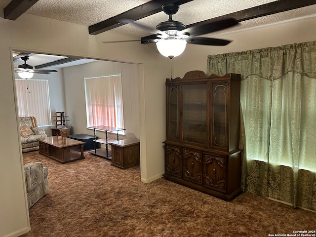 living room featuring a textured ceiling, carpet, beam ceiling, and ceiling fan