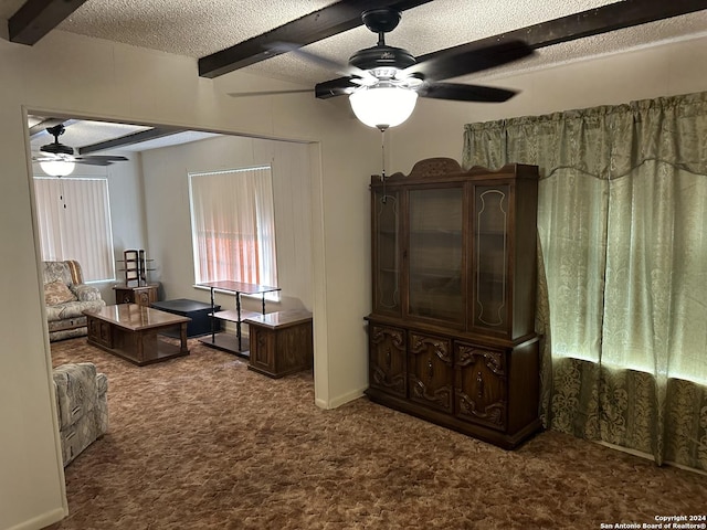 carpeted living room with beamed ceiling, ceiling fan, and a textured ceiling