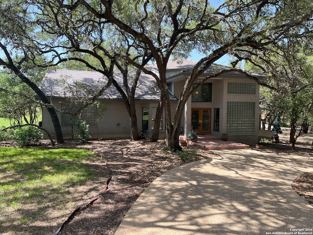 view of front of property with brick siding and french doors