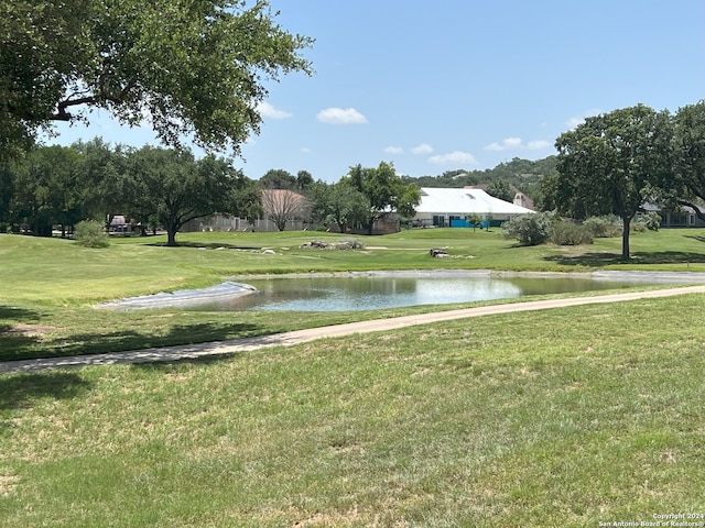 view of community featuring a water view and a lawn