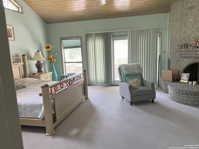 bedroom with wooden ceiling and a brick fireplace