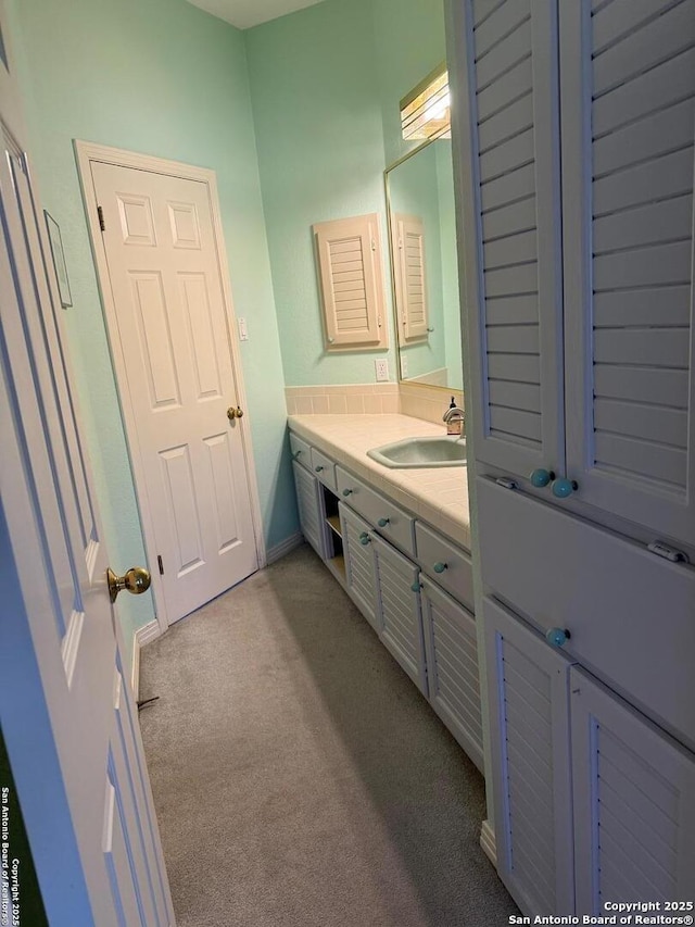 bathroom with carpet floors and vanity