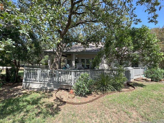 exterior space featuring a yard and a wooden deck