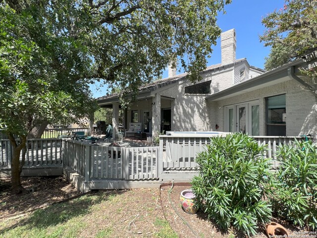 rear view of property with a wooden deck