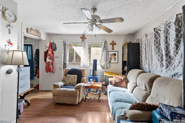 living room featuring a textured ceiling, ceiling fan, and hardwood / wood-style flooring