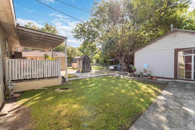 view of yard featuring a patio area and a shed