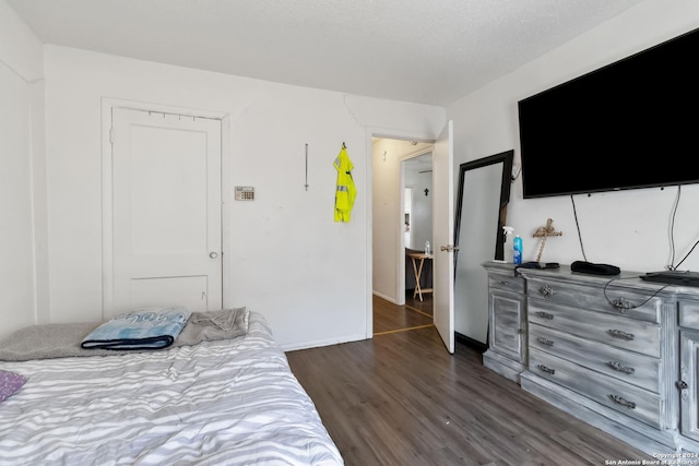 bedroom with a closet and dark hardwood / wood-style flooring