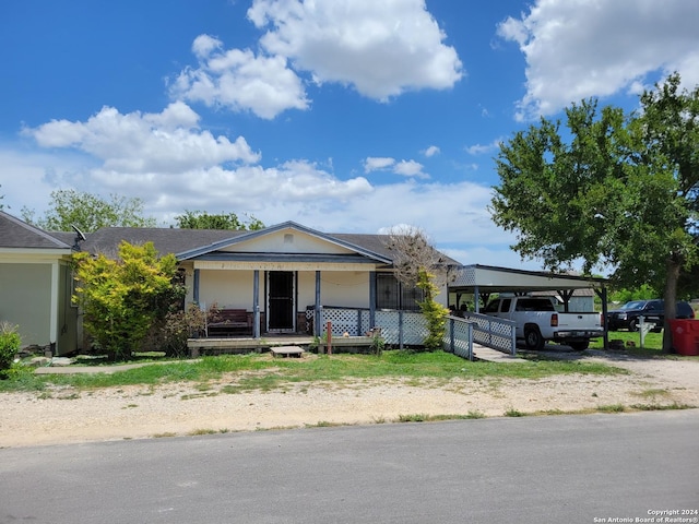 view of front of property with a carport and a porch