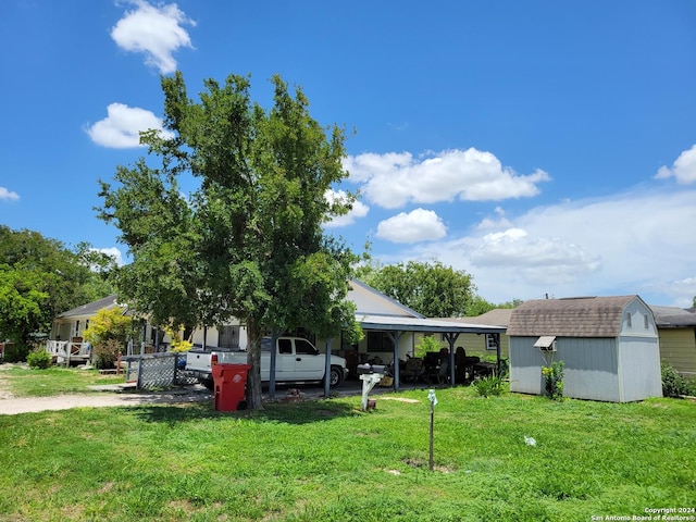 exterior space featuring a storage unit, a carport, and an outbuilding