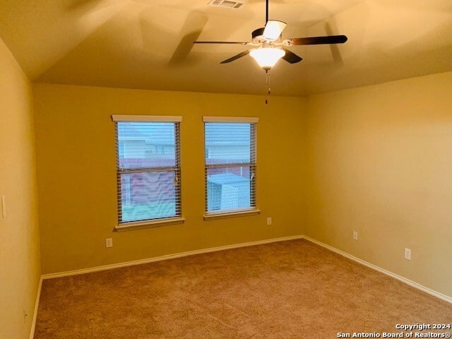 spare room with ceiling fan and carpet flooring