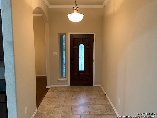 foyer entrance featuring ornamental molding